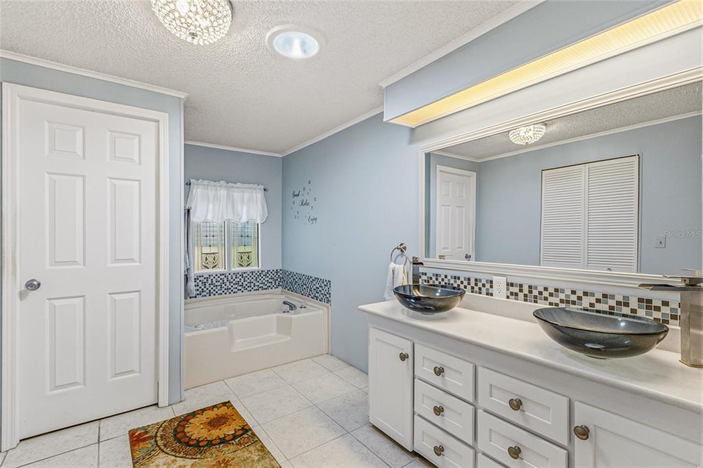 917 Cypress Street Sebastian, FL 32976 - Photo 30 of 80 a bathroom with a tub sink and mirror