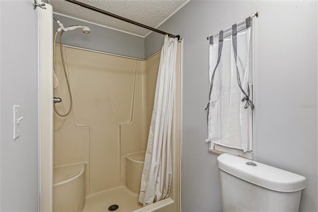 917 Cypress Street Sebastian, FL 32976 - Photo 31 of 80 a bathroom with a shower a toilet and sink