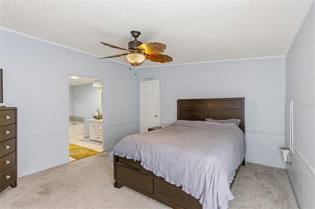 917 Cypress Street Sebastian, FL 32976 - Photo 32 of 80 a bedroom with a bed and painting on the wall