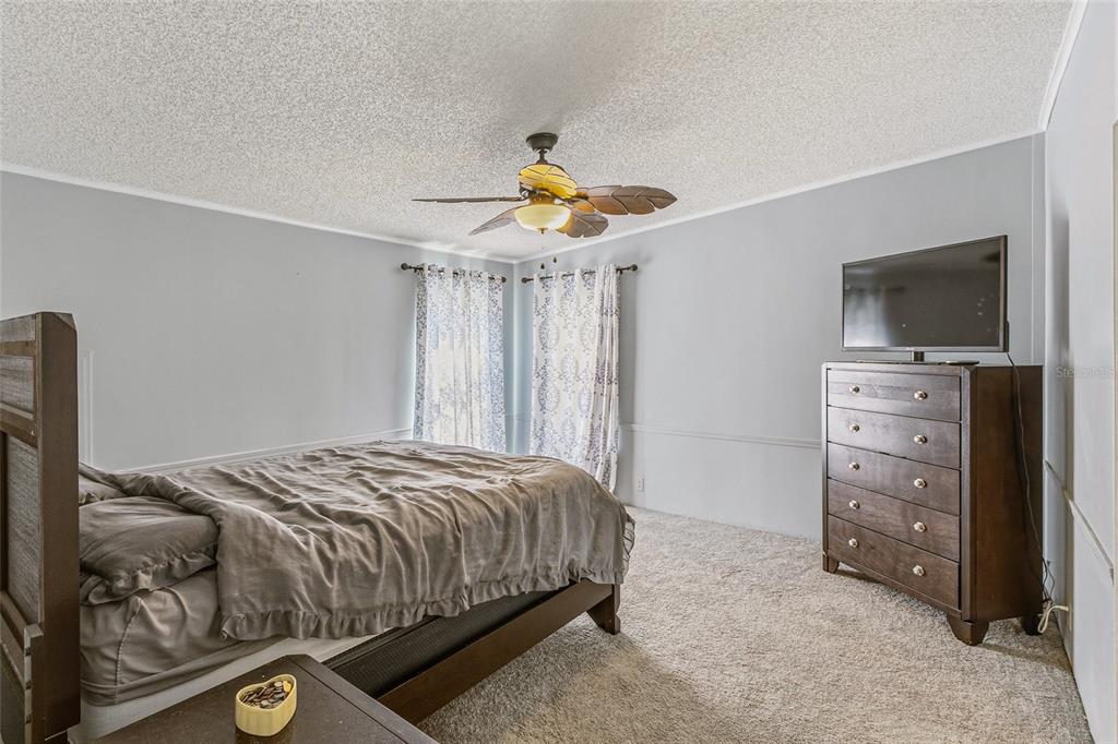 917 Cypress Street Sebastian, FL 32976 - Photo 33 of 80 a bedroom with a bed and a television