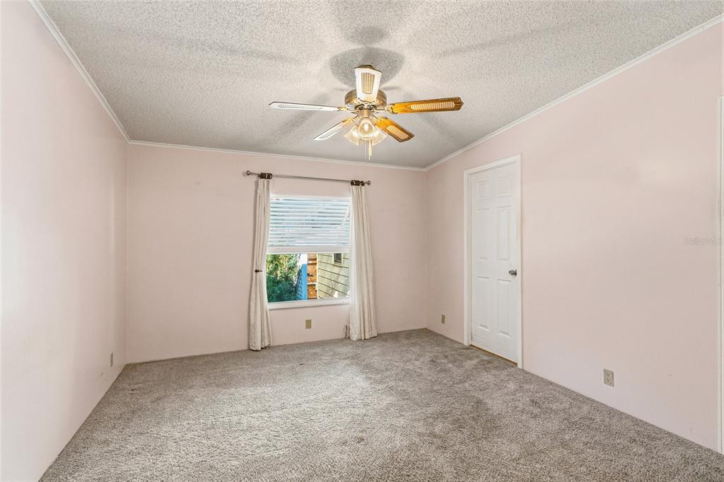 917 Cypress Street Sebastian, FL 32976 - Photo 34 of 80 an empty room with windows and fan