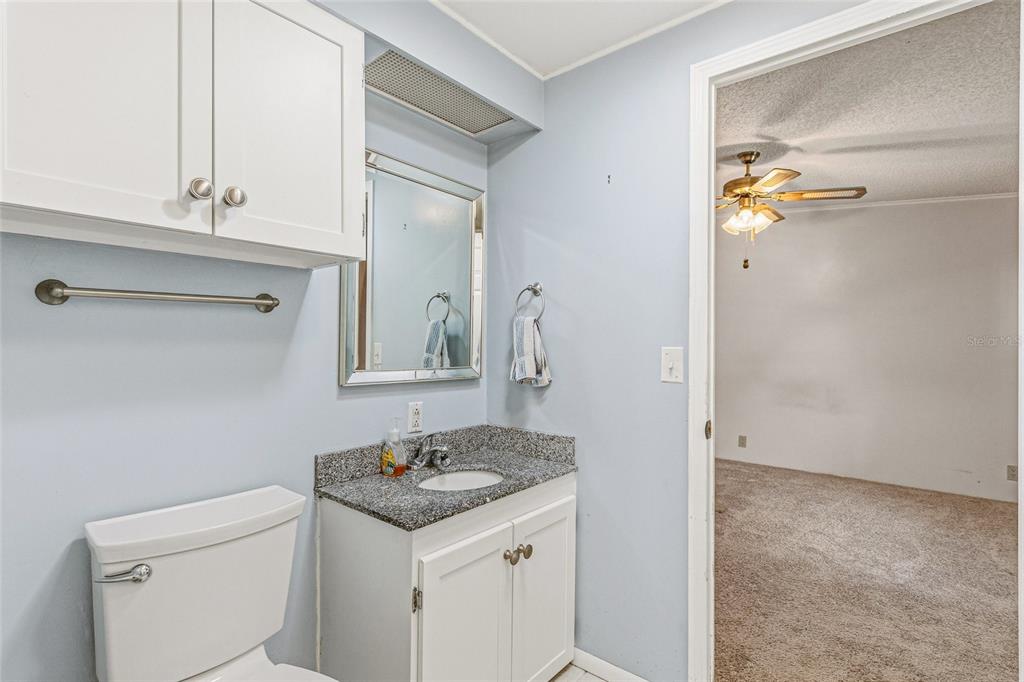 917 Cypress Street Sebastian, FL 32976 - Photo 37 of 80 a bathroom with a granite countertop sink and a mirror