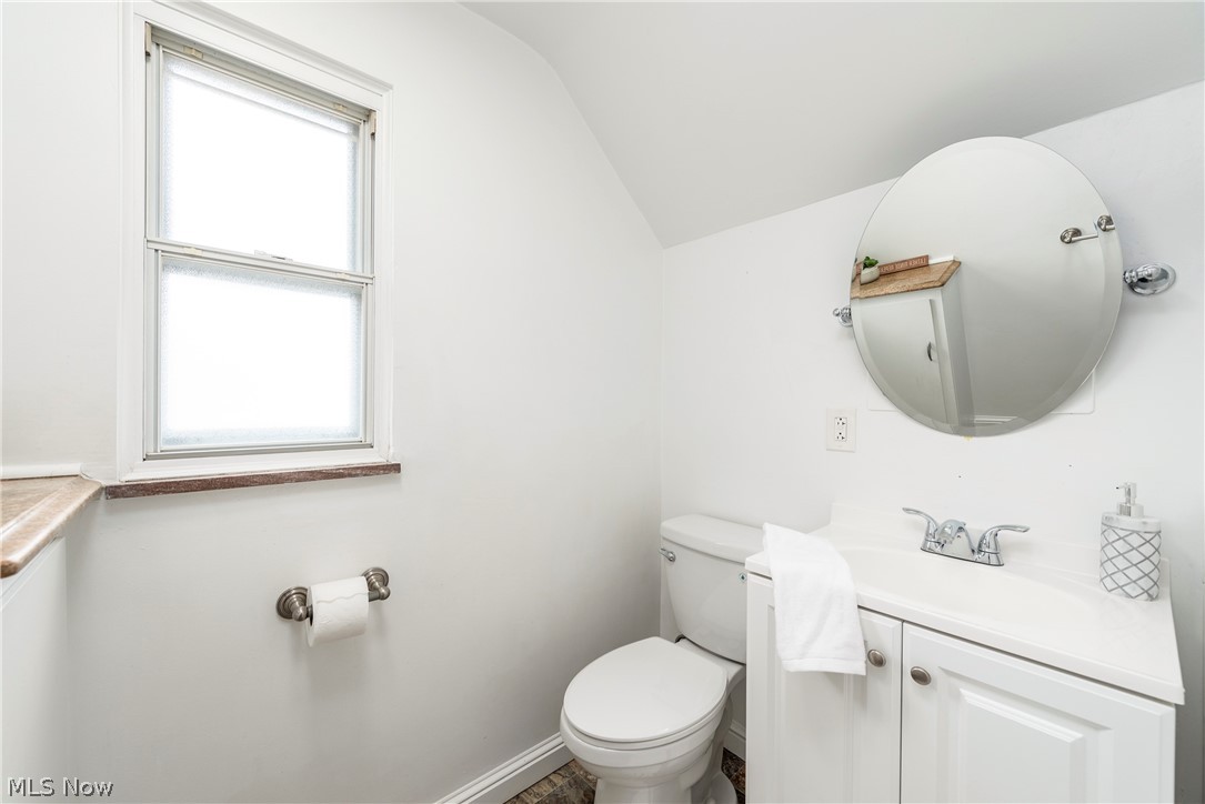 21779 Eaton Road Cleveland, OH 44126 - Photo 25 of 46 Bathroom featuring a healthy amount of sunlight, lofted ceiling, toilet, and vanity