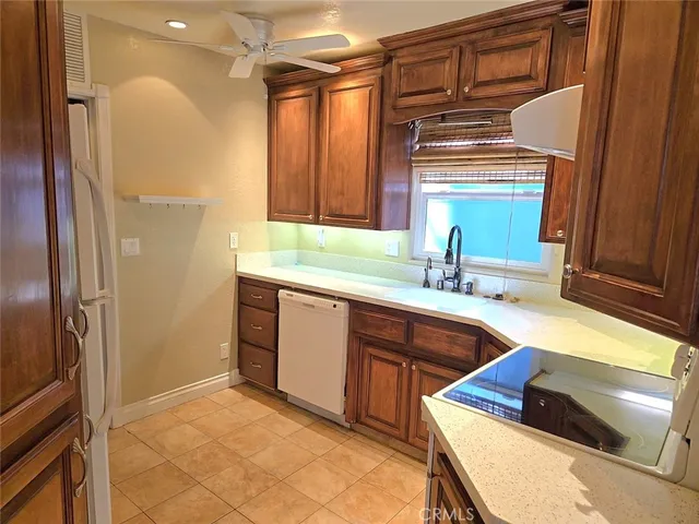 a kitchen with granite countertop a sink stainless steel appliances and cabinets