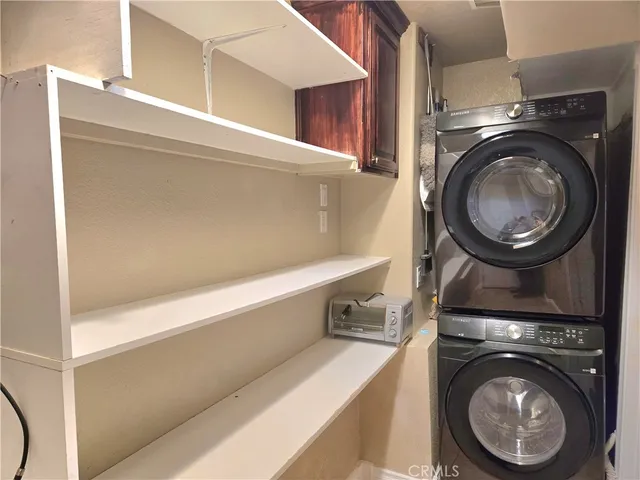 a view of entryway and kitchen with wooden floor