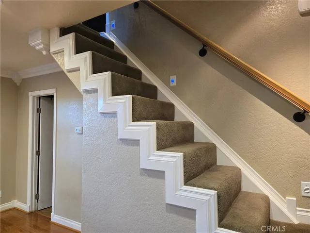 a view of a livingroom with stairs