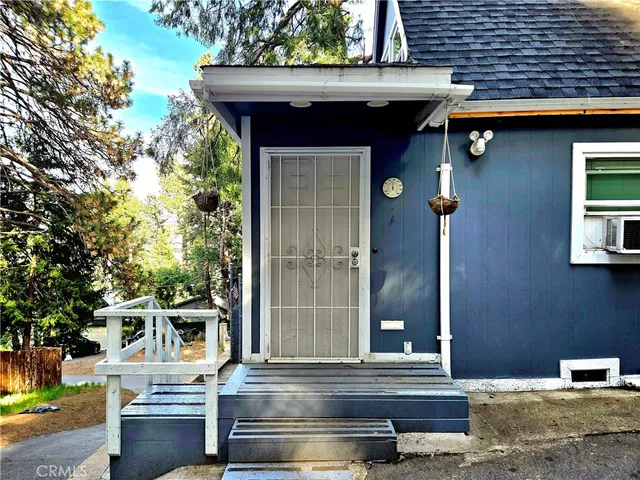 a view of front door of house with stairs