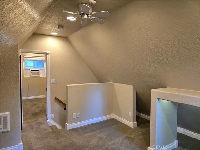 a view of a hallway with seating area