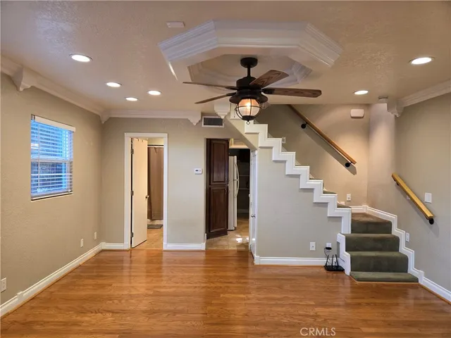 a view of entryway and hall with wooden floor