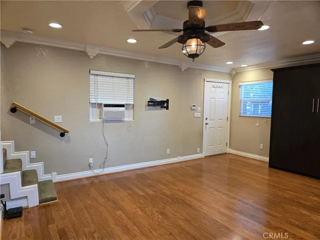 a view of an entryway with wooden floor and a livingroom