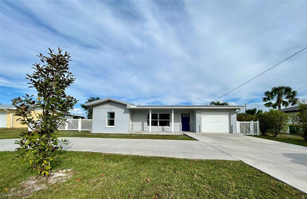 3112 Magnolia Way Punta Gorda, FL 33950 - Photo 1 of 20 a front view of a house with a garden