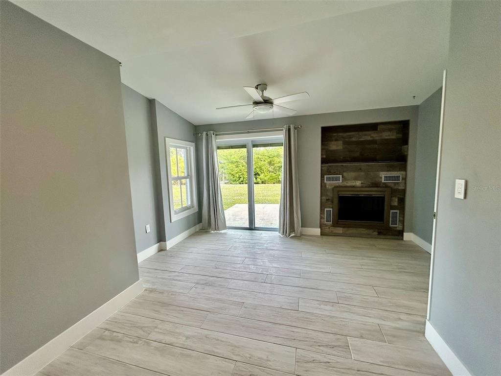 3112 Magnolia Way Punta Gorda, FL 33950 - Photo 11 of 20 an empty room with windows and a fireplace