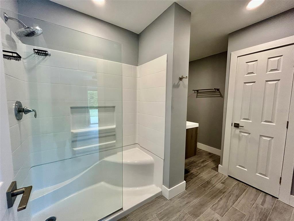 3112 Magnolia Way Punta Gorda, FL 33950 - Photo 13 of 20 a bathroom with a glass shower door and a bathtub