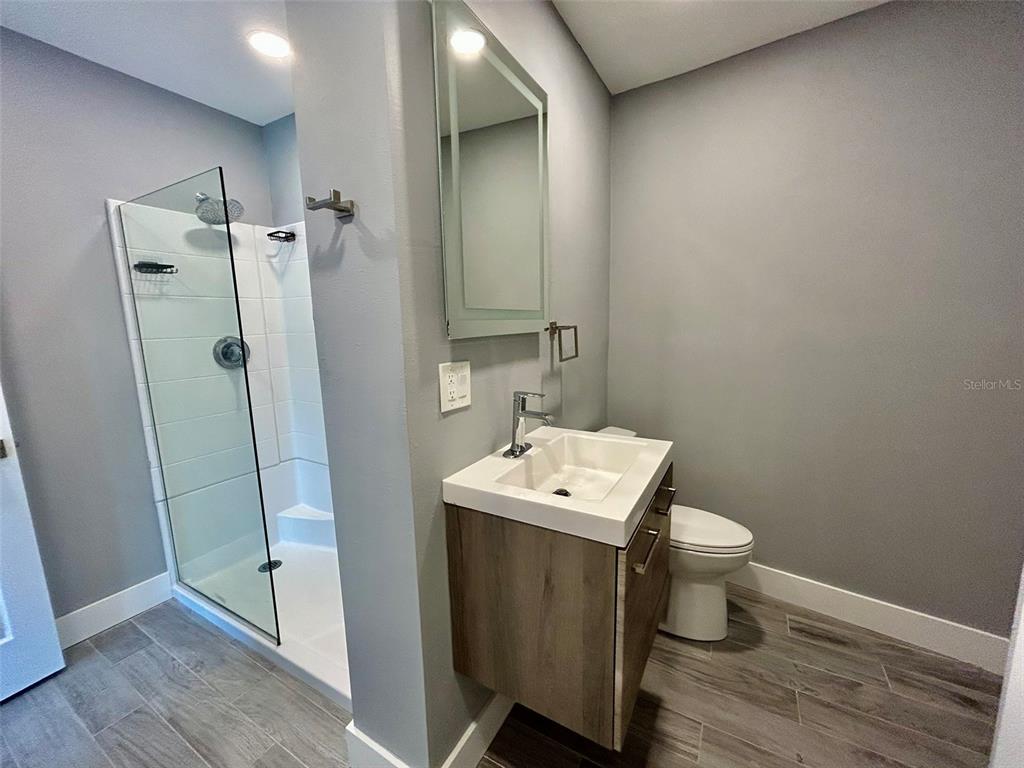 3112 Magnolia Way Punta Gorda, FL 33950 - Photo 14 of 20 a bathroom with a toilet a sink and a mirror