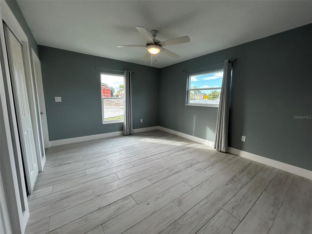 3112 Magnolia Way Punta Gorda, FL 33950 - Photo 17 of 20 an empty room with wooden floor and windows