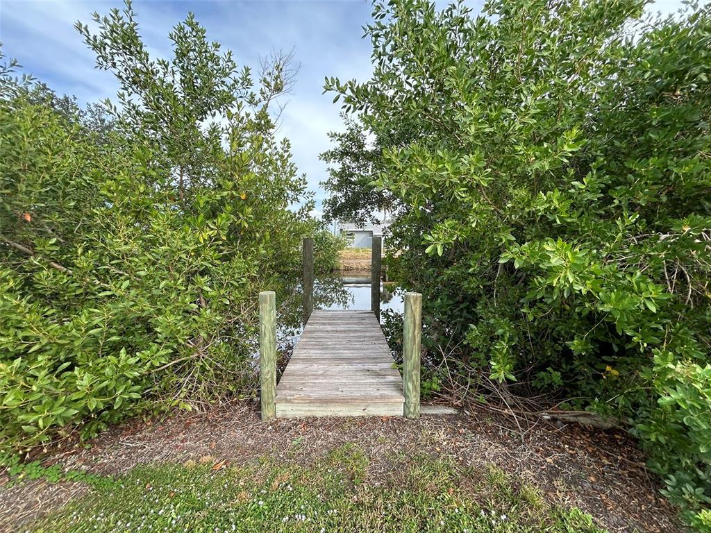 3112 Magnolia Way Punta Gorda, FL 33950 - Photo 19 of 20 a view of a pathway of a house with large trees