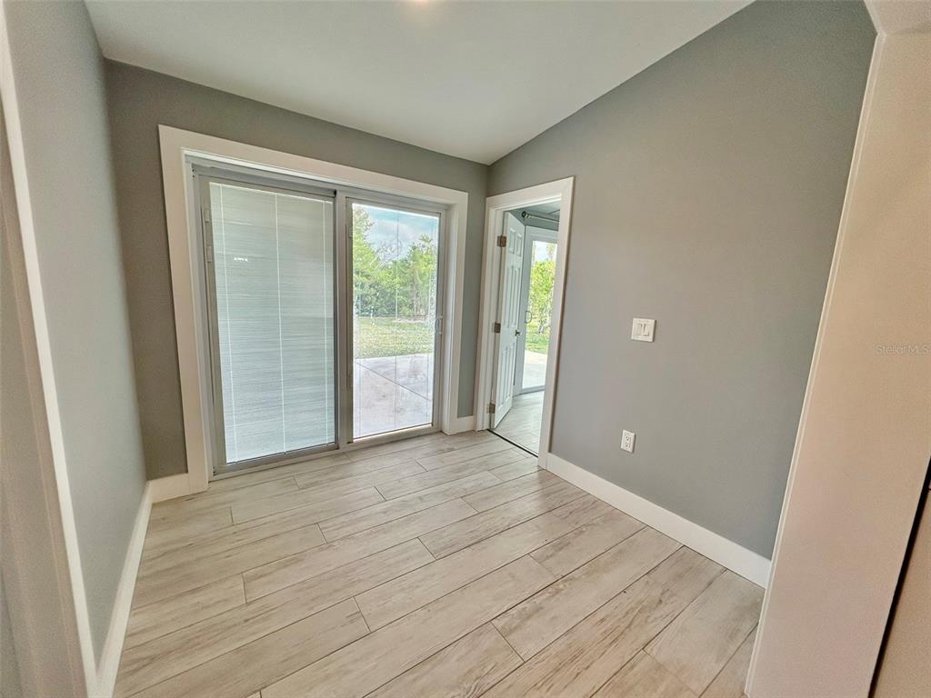 3112 Magnolia Way Punta Gorda, FL 33950 - Photo 7 of 20 a view of an empty room with wooden floor and a window