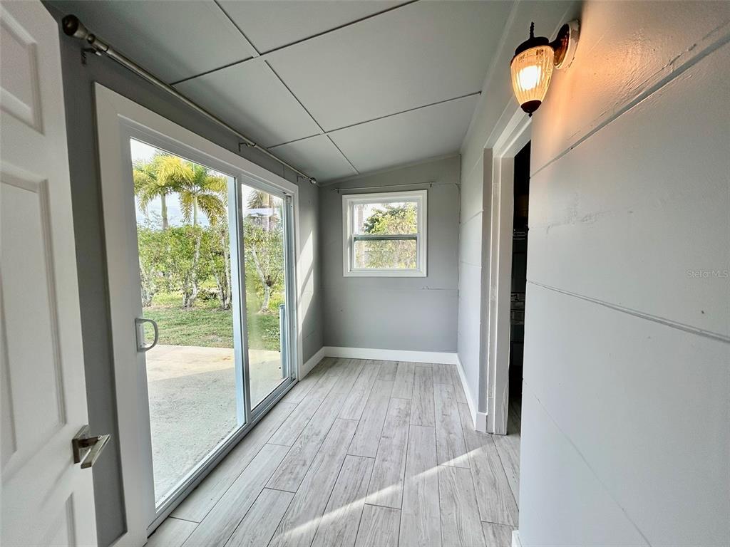 3112 Magnolia Way Punta Gorda, FL 33950 - Photo 8 of 20 a view of hallway with a large window and wooden floor