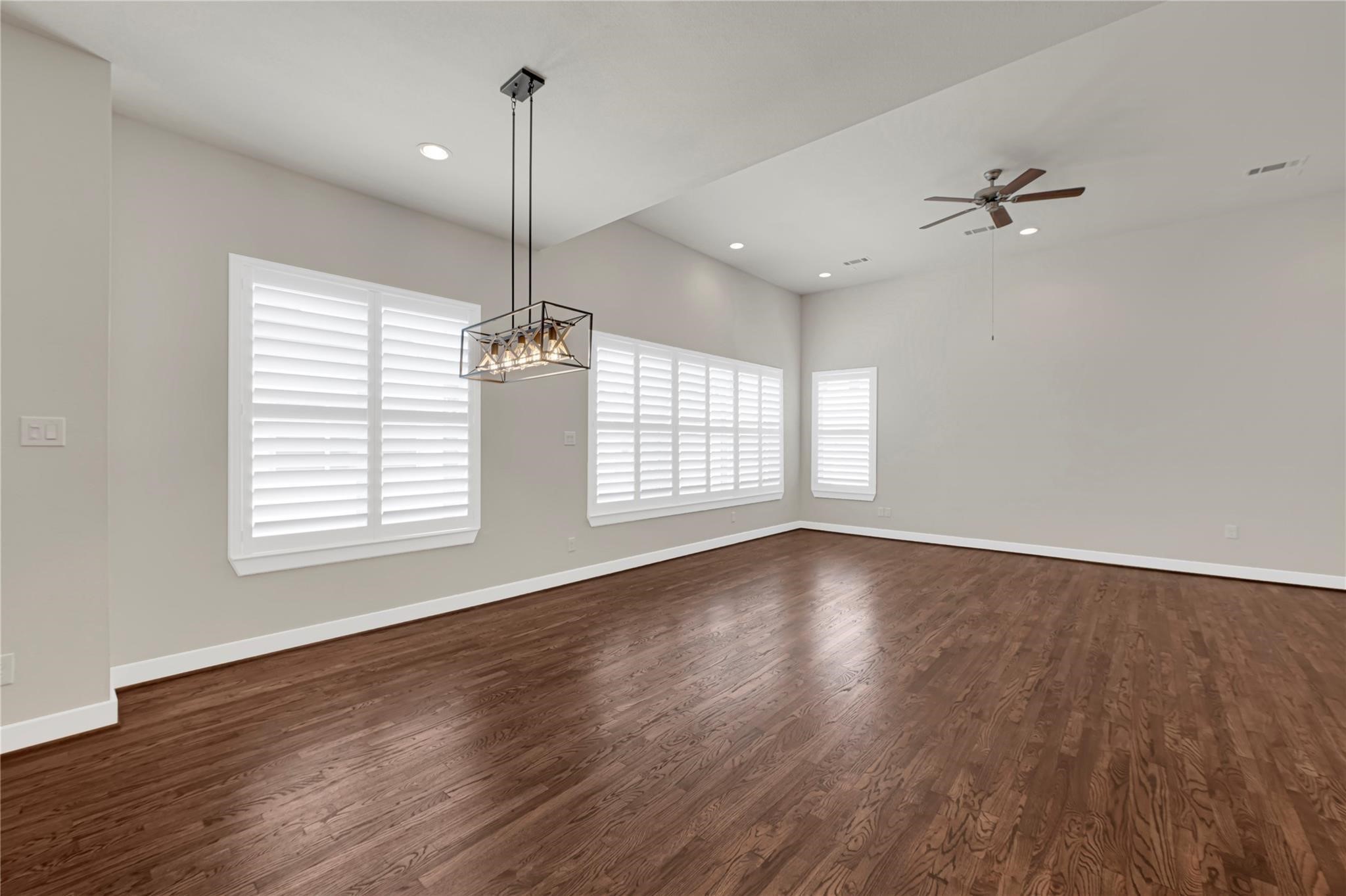 1210 Cedarpost Tree Springs Place, Unit P Houston, TX 77055 - Photo 2 of 25 an empty room with wooden floor and windows