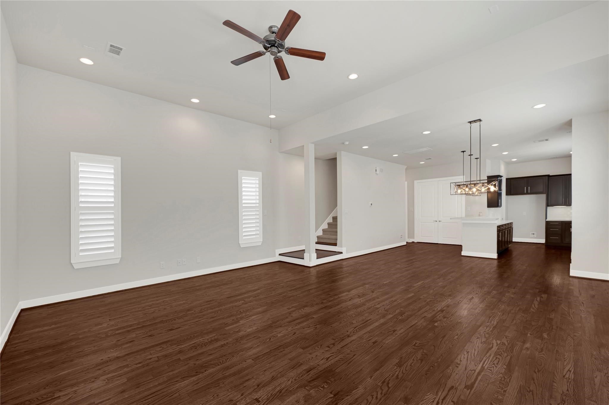 1210 Cedarpost Tree Springs Place, Unit P Houston, TX 77055 - Photo 21 of 25 a view of an empty room with wooden floor and a window