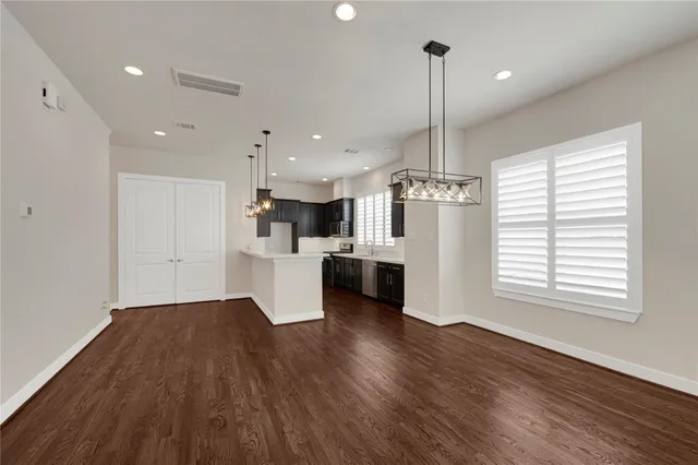 a view of kitchen with refrigerator and window