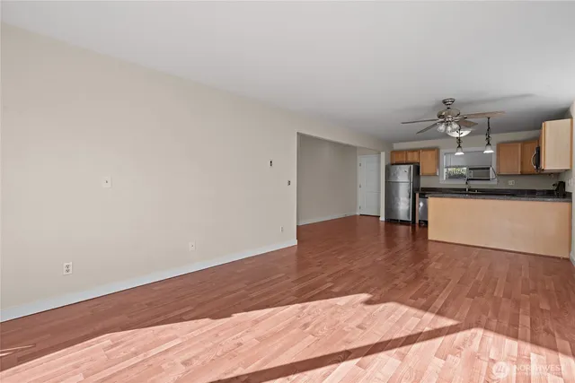 a view of a kitchen with wooden floor and a kitchen