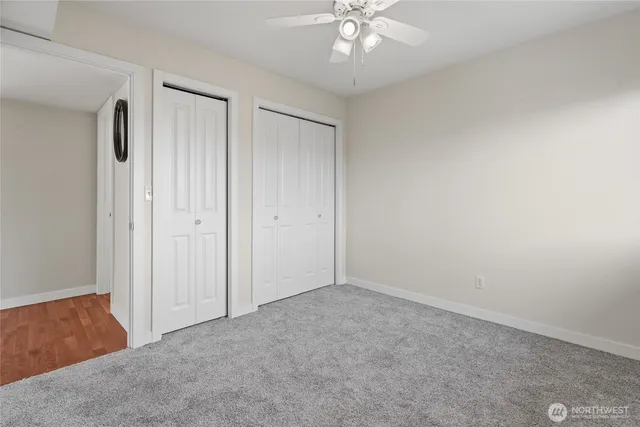 an empty room with a chandelier fan