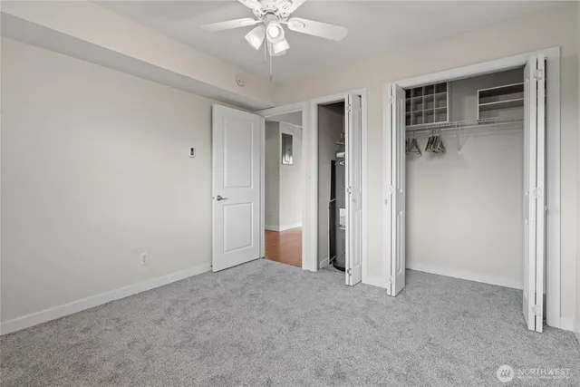 a view of an empty room with a ceiling fan