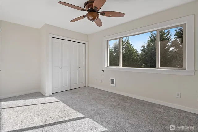 an empty room with windows and outdoor view