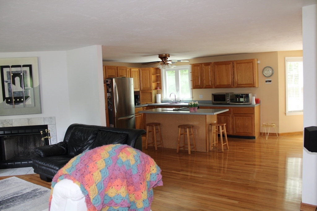 27 Gretchen Way Raynham, MA 02767 - Photo 3 of 20 a kitchen with stainless steel appliances a sink a stove a refrigerator cabinets and a dining table