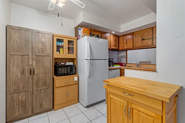 a kitchen with stainless steel appliances granite countertop a sink and a refrigerator