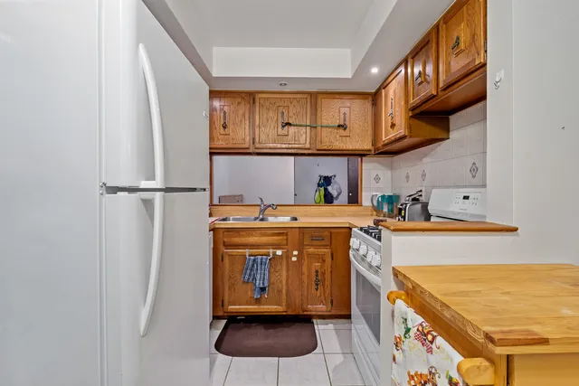 a kitchen with stainless steel appliances granite countertop a refrigerator a stove and a microwave