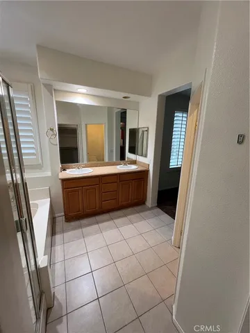 a view of an empty room with a fireplace and a window