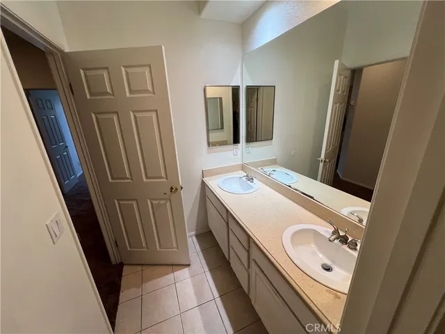 a bathroom with a sink a toilet a mirror and vanity