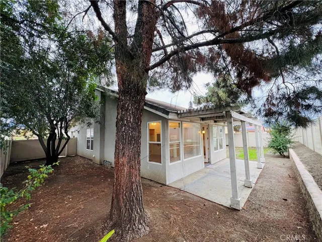 a view of a house with a tree in the forest