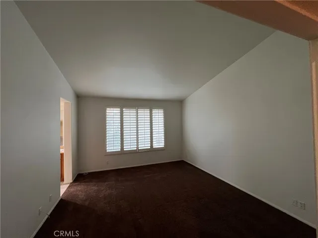 a view of an empty room and wooden floor