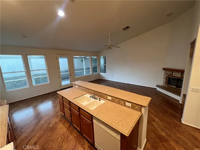 a room with wooden floor and windows