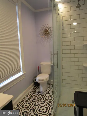 a bathroom with a toilet and a shower