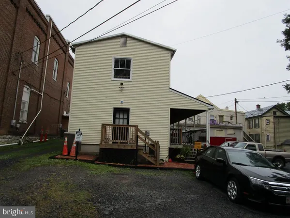 a view of a cars park in front of a house