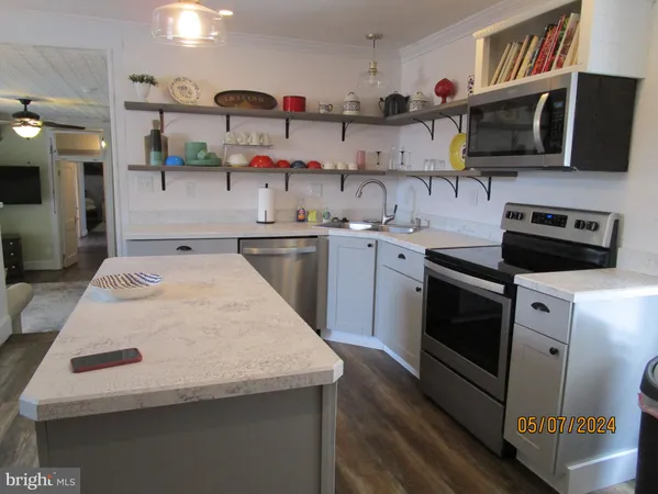 a kitchen with stainless steel appliances a stove a sink and a microwave