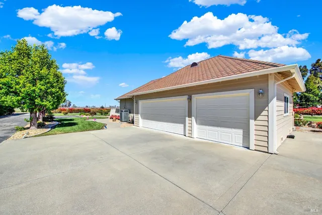 a view of a livingroom with wooden floor and a bathroom space
