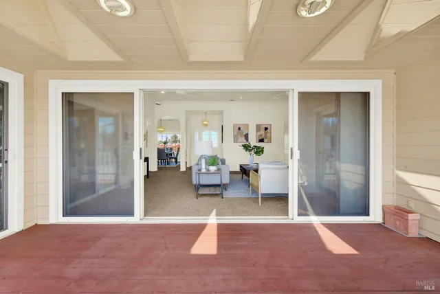 a kitchen with stainless steel appliances a stove a sink a microwave a dining table and chairs