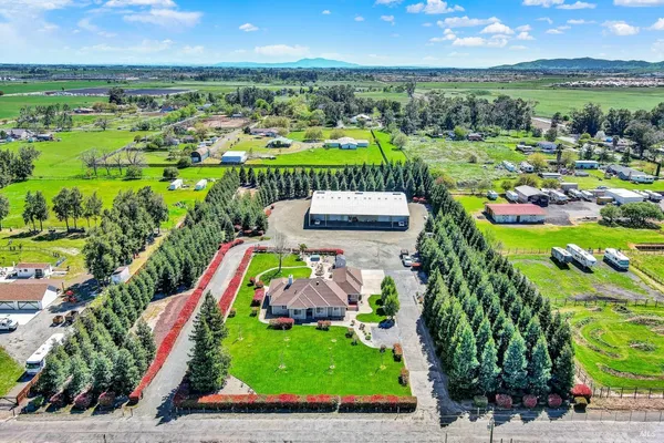 an aerial view of a house with a garden and swimming pool