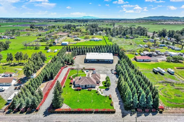 an aerial view of a house with a garden and swimming pool