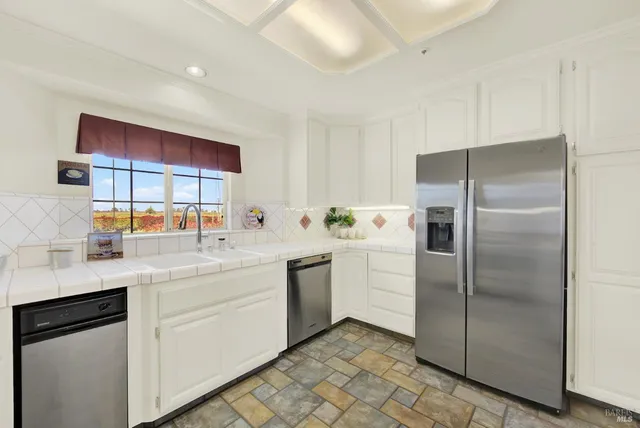 a view of a hallway with wooden floor and a potted plant