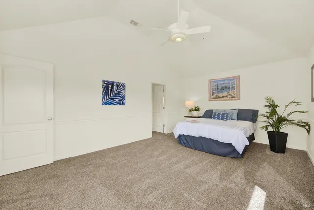 a green field with lots of trees in the background