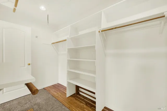 a aerial view of a house with a big yard and large trees