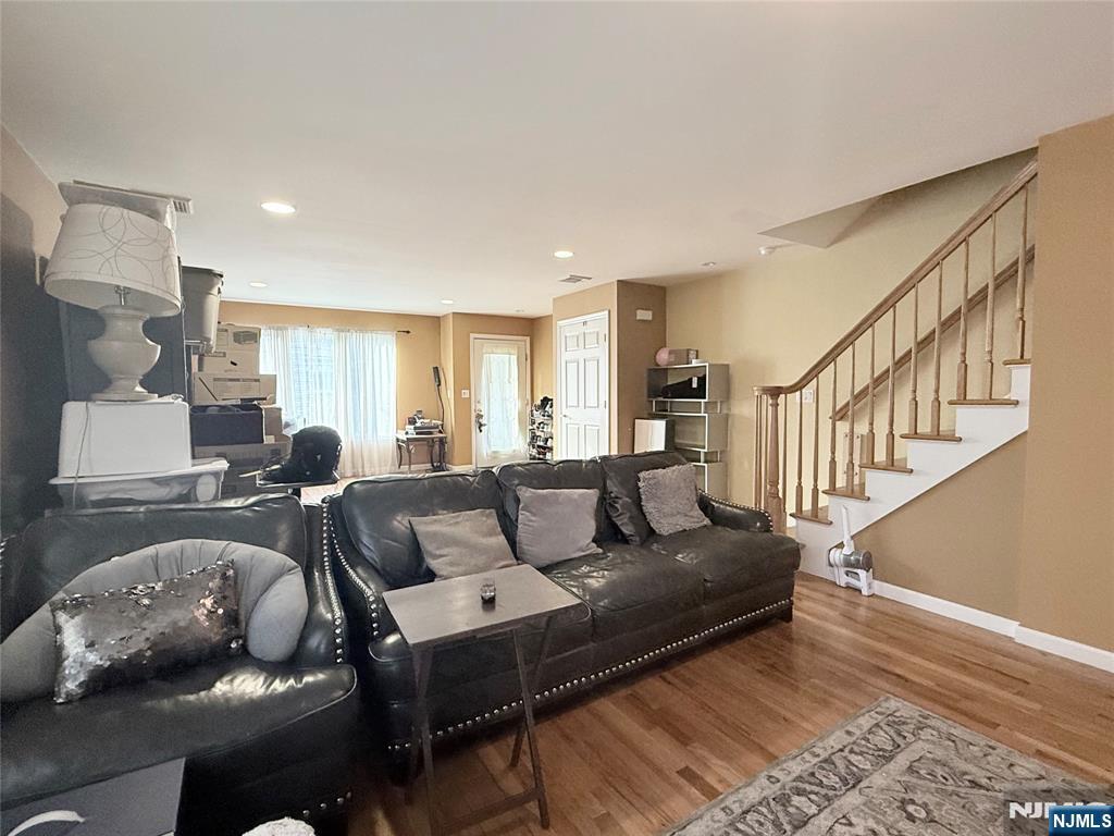 58 River Street, Unit B Lodi, NJ 07644 - Photo 11 of 11 a living room with furniture and a wooden floor