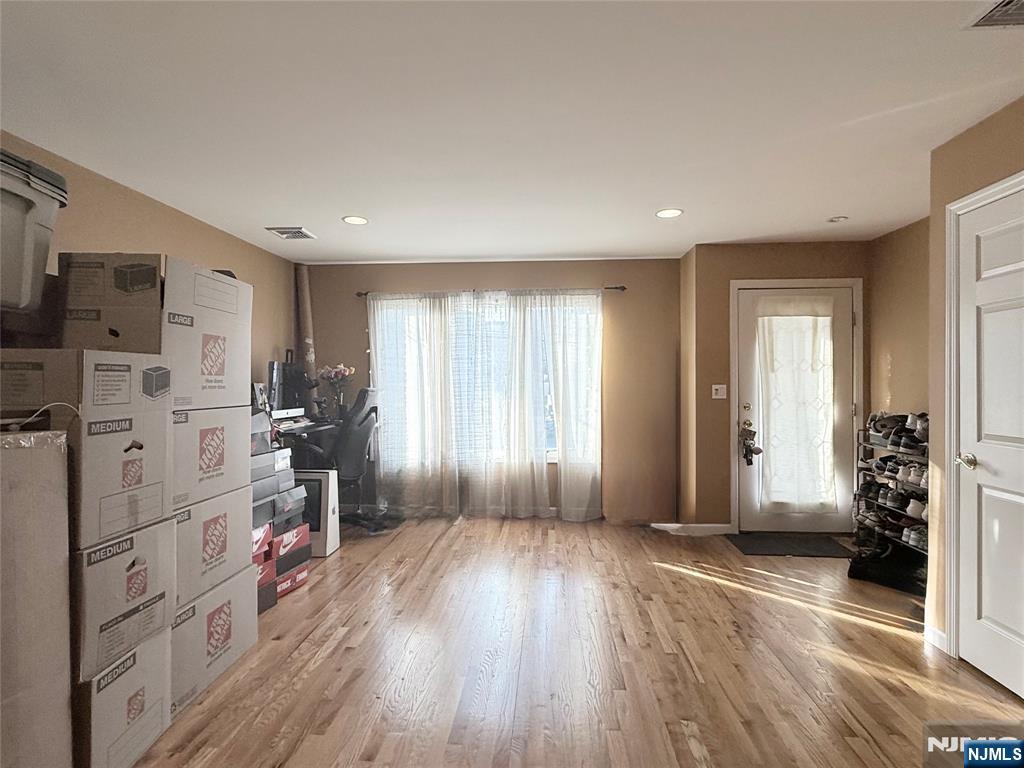 58 River Street, Unit B Lodi, NJ 07644 - Photo 3 of 11 a view of livingroom with hardwood floor and a window