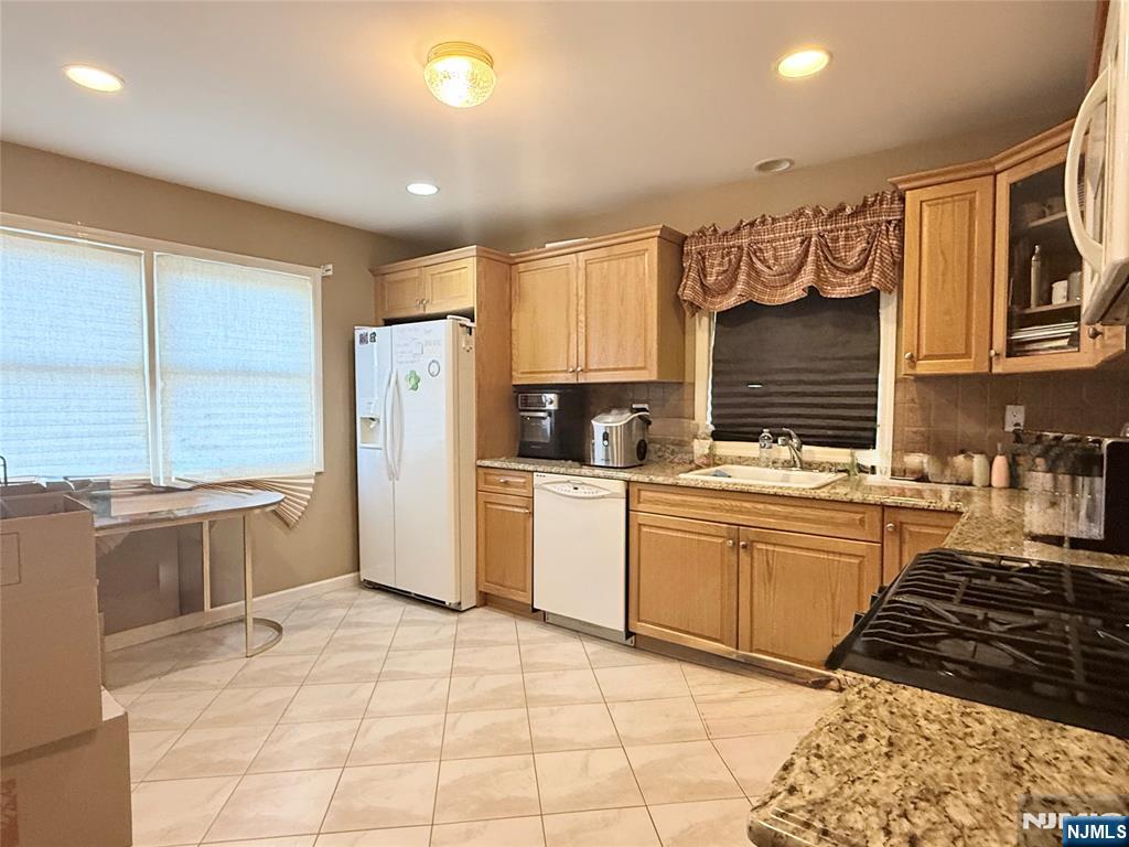 58 River Street, Unit B Lodi, NJ 07644 - Photo 6 of 11 a kitchen with a stove a sink and a refrigerator